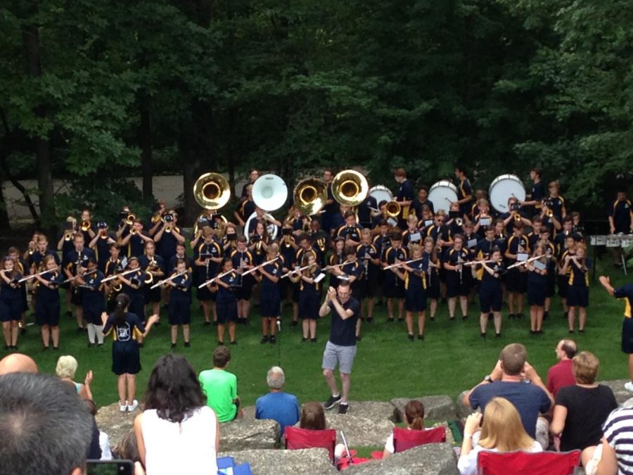 Marching band members play for their families at the band camp picnic.