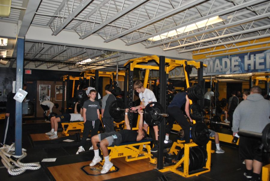 Lifting performances: Members of the OHS football team congregate in the weight room after school for practice and to increase strength and endurance.