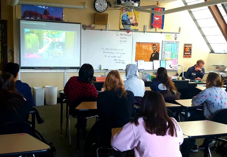 Mid-week update: Sophomore students in AP U.S. History and Sociology teacher John Moore’s homeroom watch the announcements before participating in the day’s scheduled activity.
