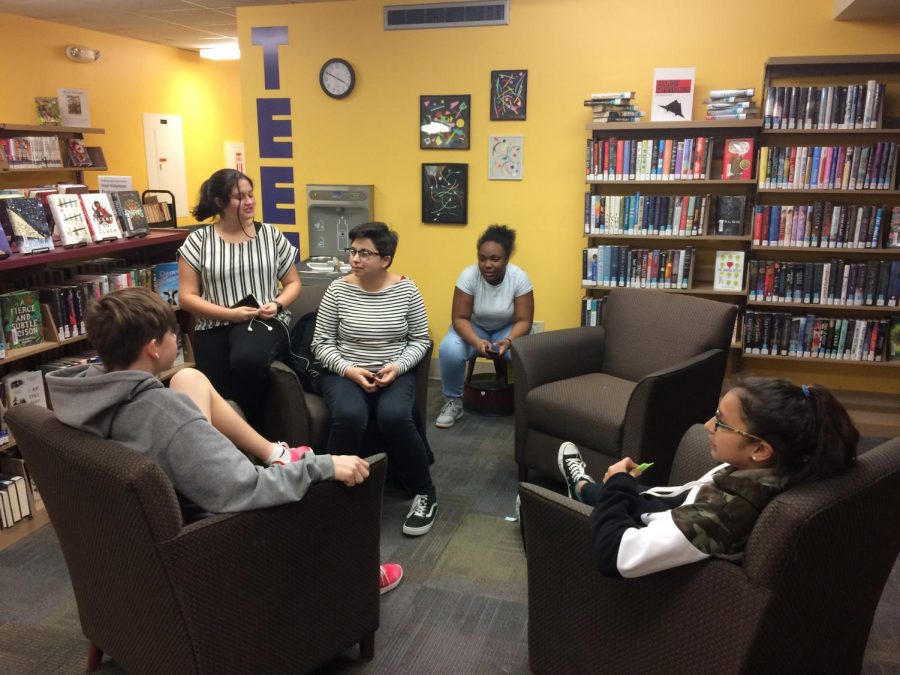 Diamond Martinez (10), center, and friends sit in the teen area at Wright Memorial Library to relax and talk after school.