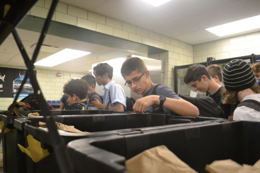 Binning Bags: The cafeteria is now lined with black containers, which consist of bags of lunch assortments.