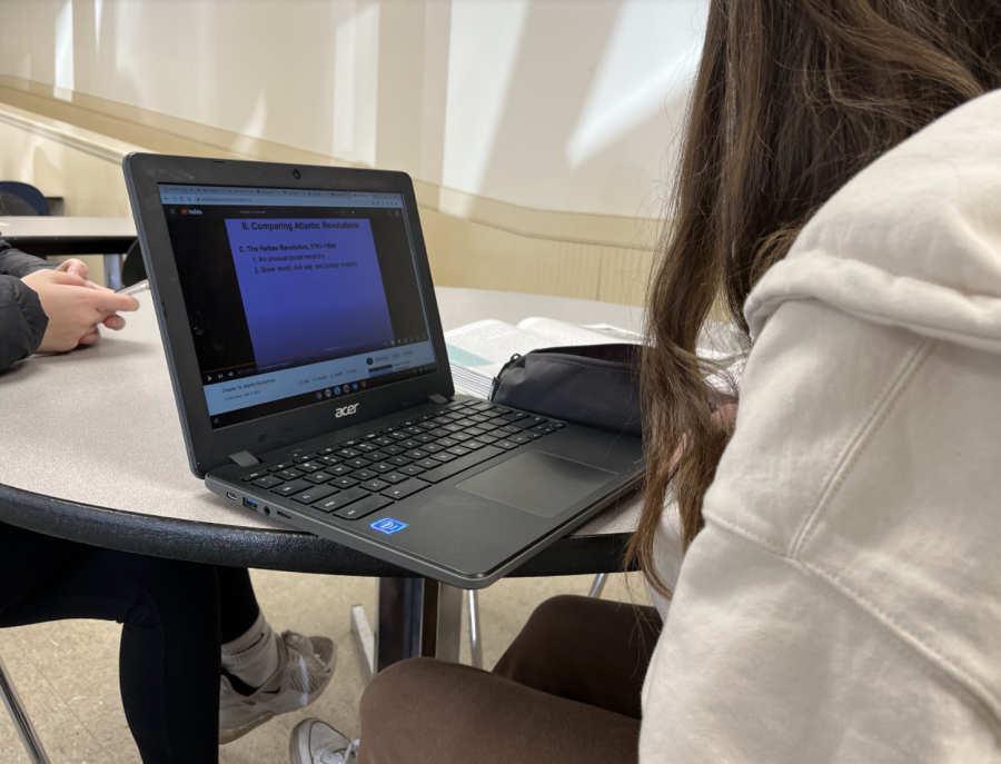 Research and Resources: Anah Williams (9) works on an assignment for AP World History.  Dutch Kulka (10) said, “Most youtube videos just dont work, and mainly in health, its stupid hard to get onto the website our teacher wants us on.” Photo by: Adam Chodowski