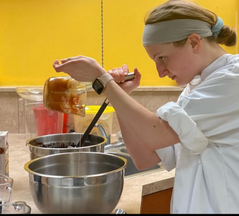 Busy Baker: In the midst of a new project, Cate Bowman (12) takes great precision in her craft. Bowman said, “I decided being a chef would be my career freshman or sophomore year, when I really became interested in the CIA.” Photo by: Cate Bowman