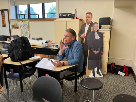John Moore watches his history students’ history mystery presentations. Max Kiernan (10) said, “Mr. Moore always made class fun with his sarcastic sense of humor and engaging activities.”