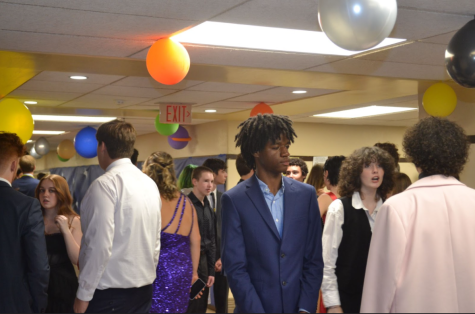 Stepping Out: Students crowd the decorated halls to escape the loud music, crowded gym, and to enjoy some snacks. Nathaniel Upton (11) said, “I think the decorations are good, but we could use some soda and pizza.” Photo by: Paige Simon