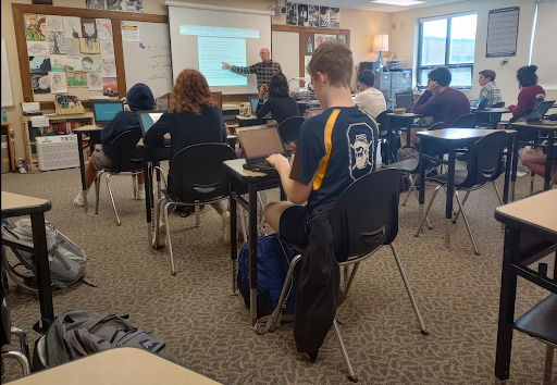 Studious Sophomores: Students in Bryan Ammer’s 5th period English class go over themes of self transformation and justice for a paper. When we are responsible for the research, composition and editing of a piece of writing, it is truly authentic to us, Gabriella Laperle (10) said.
