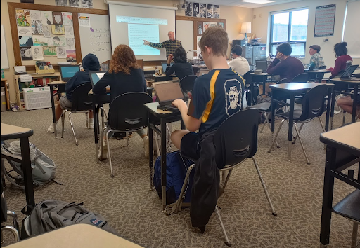 Studious Sophomores: Students in Bryan Ammer’s 5th period English class go over themes of self transformation and justice for a paper. "When we are responsible for the research, composition and editing of a piece of writing, it is truly authentic to us," Gabriella Laperle (10) said.