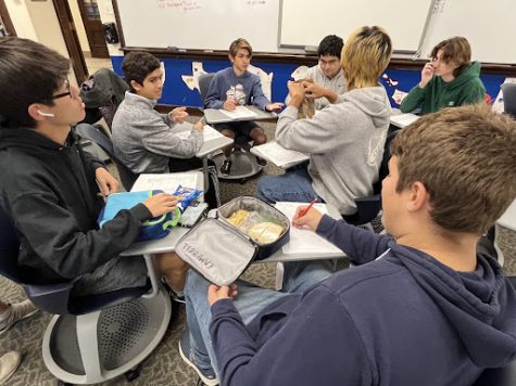 Building Bonds: AcaDec students work together on practice quizzes at lunch to prepare for their first competition. Sia Zois (10) said, “Its not just individual work, its very collaborative. If I dont understand something I can go to Joseph.”