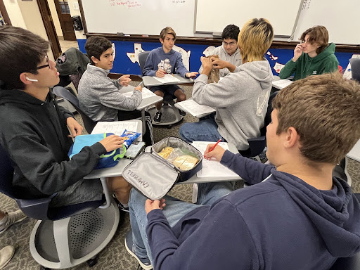 Building Bonds: AcaDec students work together on practice quizzes at lunch to prepare for their first competition. Sia Zois (10) said, “It's not just individual work, it's very collaborative. If I don't understand something I can go to Joseph.”