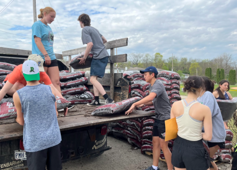 Joint Effort: Students pile bags of mulch onto the truck so that they can be delivered to customers who pre-ordered. Both members of student council took part in hosting the sale, as well as other student volunteers. 
