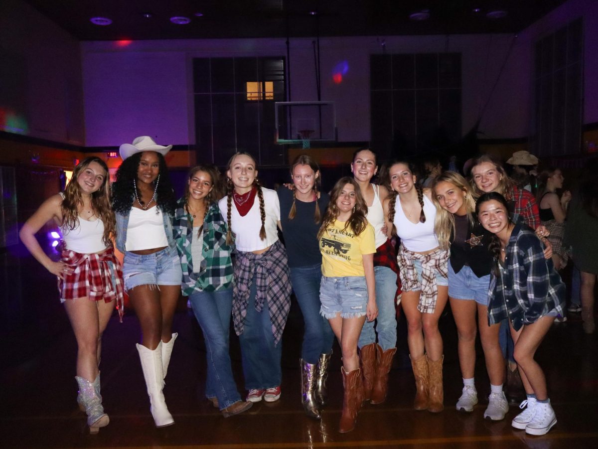 Group Up: Seniors girls pose for a group photo on the dance floor.