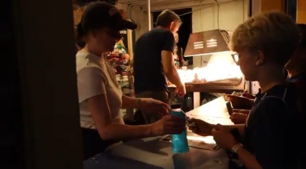 Band parents serving food at concession stand.